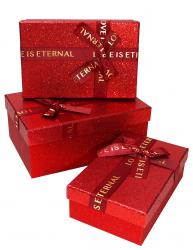 Набор из трёх красных прямоугольных подарочных коробок с бантом из ленты, отделка фактурной блестящей бумагой, размер 23*16*9,5 см.
