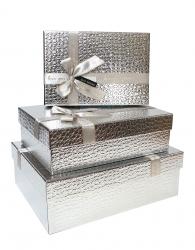 Набор из трёх прямоугольных блестящих серебряных подарочных коробок с бантом из ленты, отделка фактурной бумагой, размер 33*24*11,5 см.