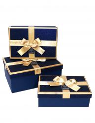 Набор из трёх синих прямоугольных подарочных коробок с золотистыми краями и бантом из ленты, отделка фактурной блестящей бумагой, размер 22*16*9,5 см.